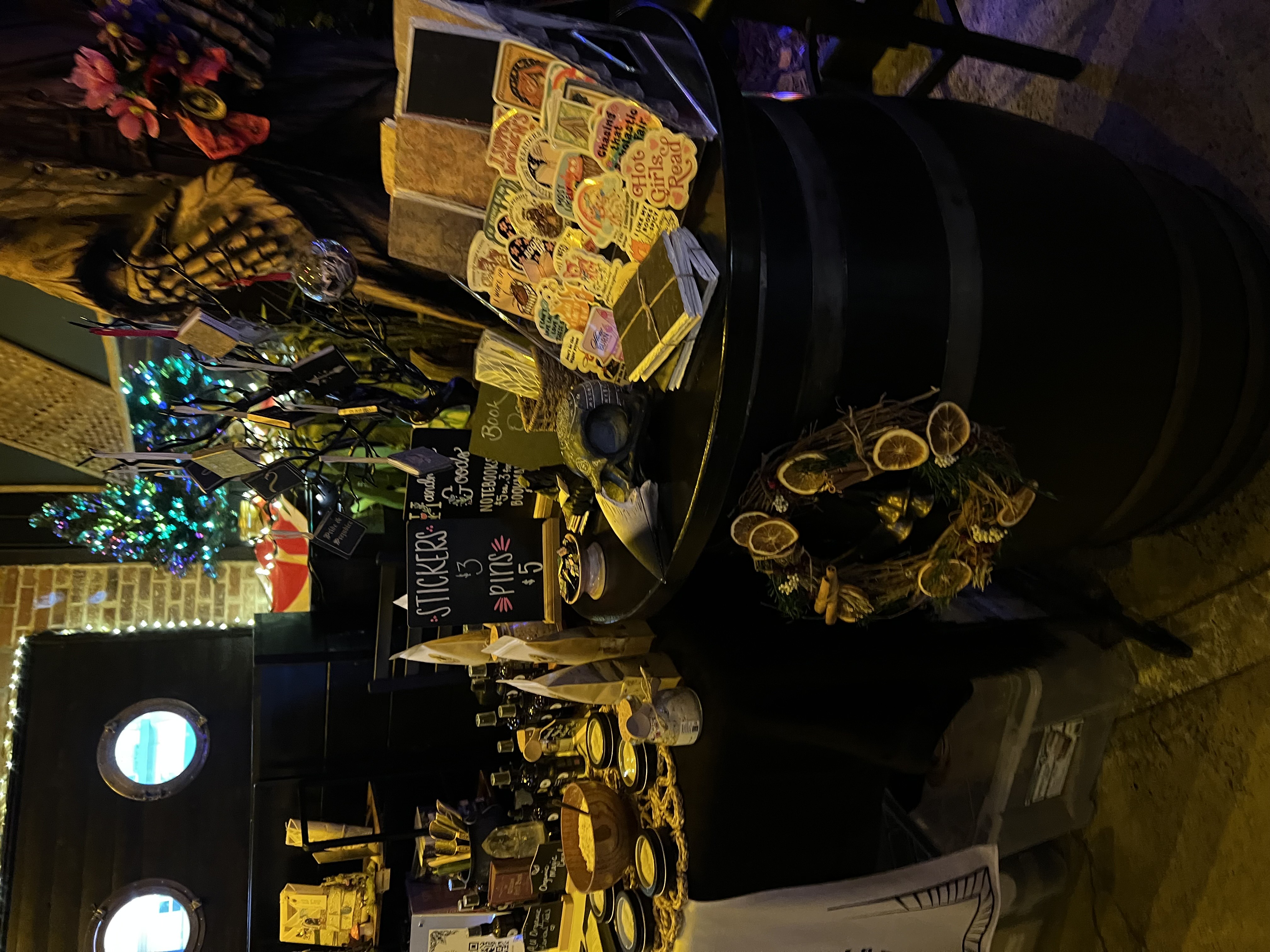 Night market table with stickers, candles, and bookish goods